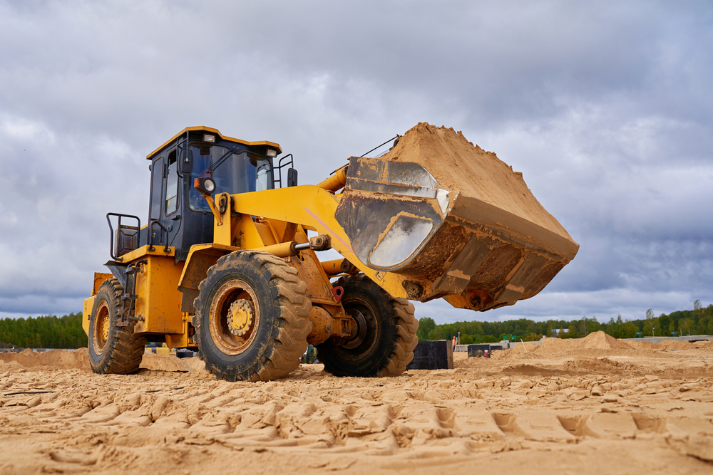 Powerful,Yellow,Bulldozer,Crumbles,Sand,At,Construction,Site