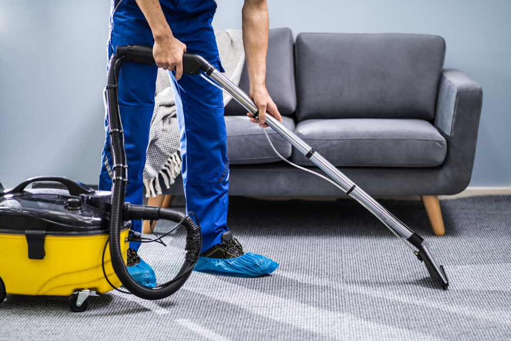 Photo,Of,Janitor,Cleaning,Carpet,With,Vacuum,Cleaner