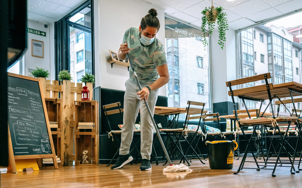 Worker,With,Mask,Mopping,The,Floor,Of,A,Restaurant